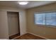 Bedroom featuring wood-style floors, closet with sliding doors, and a bright window at 549 E Mckellips Rd # 18, Mesa, AZ 85203