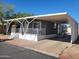Charming single-Gathering home with covered front porch and carport, perfect for enjoying outdoor living at 549 E Mckellips Rd # 18, Mesa, AZ 85203
