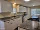 Modern kitchen with sleek granite countertops, stainless steel appliances, and ample cabinet space at 549 E Mckellips Rd # 18, Mesa, AZ 85203