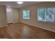 Inviting living room featuring two bright windows with ample natural light and hardwood floors at 549 E Mckellips Rd # 18, Mesa, AZ 85203