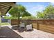 Back patio featuring brick flooring, landscaping, and a modern fence at 5815 N 10Th Pl, Phoenix, AZ 85014