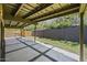 Covered patio features a concrete grid, gravel accents, and a wooden fence, offering a private outdoor space at 5815 N 10Th Pl, Phoenix, AZ 85014