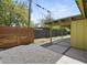 The backyard features a covered patio, gravel, wood fence, and a view of greenery at 5815 N 10Th Pl, Phoenix, AZ 85014