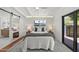 Bright bedroom with a ceiling fan, white walls, a sliding bathroom door and a view of the backyard at 5815 N 10Th Pl, Phoenix, AZ 85014