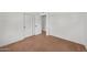 This bedroom has white walls, light brown carpet, and access to the hallway through a door on the back wall at 5815 N 10Th Pl, Phoenix, AZ 85014