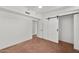 A bedroom with white walls, a ceiling fan, and a sliding barn door closet at 5815 N 10Th Pl, Phoenix, AZ 85014