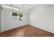 A secondary bedroom featuring white walls, a ceiling fan, and one large window at 5815 N 10Th Pl, Phoenix, AZ 85014