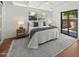 Bright bedroom with a ceiling fan, white walls, plenty of sunlight and a view of the backyard at 5815 N 10Th Pl, Phoenix, AZ 85014