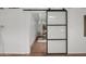 Spacious bedroom with exposed brick, concrete floors and glass slider separating the office space at 5815 N 10Th Pl, Phoenix, AZ 85014