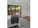 This bedroom has a view of the patio with a white chair, white walls, and grey throw at 5815 N 10Th Pl, Phoenix, AZ 85014