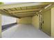 Open carport featuring a concrete floor and an adjacent entrance to the home at 5815 N 10Th Pl, Phoenix, AZ 85014