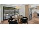 Dining room with a wood table, black chairs, and sliders to the back patio at 5815 N 10Th Pl, Phoenix, AZ 85014
