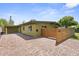 Exterior of home with brick driveway, modern wood fence, and carport at 5815 N 10Th Pl, Phoenix, AZ 85014