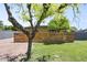 Front yard featuring new sod, decorative wood fence, and trees at 5815 N 10Th Pl, Phoenix, AZ 85014
