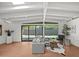 Sunlit living area featuring beamed ceilings and seamless indoor-outdoor flow at 5815 N 10Th Pl, Phoenix, AZ 85014
