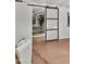 Open living room with sliding barn door to reveal a built-in desk and lots of natural light at 5815 N 10Th Pl, Phoenix, AZ 85014