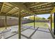 Covered patio boasts a concrete grid design, two white chairs, and backyard views at 5815 N 10Th Pl, Phoenix, AZ 85014