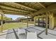 Covered patio features concrete grid, two white chairs, and views of the grassy backyard at 5815 N 10Th Pl, Phoenix, AZ 85014