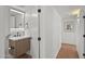 A powder room with a modern vanity, mirror and decorative lighting at 5815 N 10Th Pl, Phoenix, AZ 85014