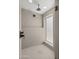 Modern shower with a large shower head, large window and tiled walls at 5815 N 10Th Pl, Phoenix, AZ 85014
