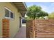 Side yard of home with lush foliage, brick patio, and horizontal privacy fence at 5815 N 10Th Pl, Phoenix, AZ 85014