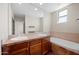 Bathroom featuring double sinks, tile countertops, a large mirror, and a soaking tub at 625 S Roosevelt St, Tempe, AZ 85281