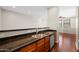 Kitchen area with dark countertops, wood cabinets and stainless steel dishwasher at 625 S Roosevelt St, Tempe, AZ 85281