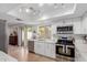 Modern white kitchen featuring stainless steel appliances and access to the outdoor patio at 6350 N 78Th St # 280, Scottsdale, AZ 85250