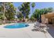 Community pool with tables and chairs under umbrellas, mature trees, and inviting poolside seating at 6350 N 78Th St # 280, Scottsdale, AZ 85250