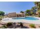 Community pool features a sun deck with chairs, tables with umbrellas, and beautiful landscape design at 6350 N 78Th St # 280, Scottsdale, AZ 85250
