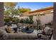 Inviting backyard with mature landscaping, stone accents, and cozy seating area at 6767 E Nightingale Star Cir, Scottsdale, AZ 85266