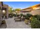 Backyard showcasing sun loungers and dining area with mature landscaping for privacy at 6767 E Nightingale Star Cir, Scottsdale, AZ 85266