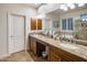 Bathroom featuring dual vanities, granite countertops, and a large mirror at 6767 E Nightingale Star Cir, Scottsdale, AZ 85266