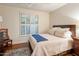 Cozy bedroom with wood floors, shuttered windows, and a comfortable-looking bed with a blue throw at 6767 E Nightingale Star Cir, Scottsdale, AZ 85266