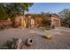Beautiful exterior view of home at twilight, with desert landscaping and illuminated pathway at 6767 E Nightingale Star Cir, Scottsdale, AZ 85266