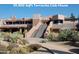 Expansive Terravita Clubhouse featuring layered architecture and lush desert landscaping at 6767 E Nightingale Star Cir, Scottsdale, AZ 85266