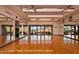 Bright, mirrored fitness room with hardwood floors and a wall of windows overlooking a scenic view at 6767 E Nightingale Star Cir, Scottsdale, AZ 85266