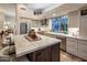 Bright kitchen features large island with marble countertop, stainless appliances, and backyard views at 6767 E Nightingale Star Cir, Scottsdale, AZ 85266