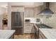 Stylish kitchen with stainless steel appliances, tiled backsplash, and custom cabinetry at 6767 E Nightingale Star Cir, Scottsdale, AZ 85266