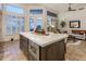 Open concept kitchen with island featuring a marble countertop, microwave, and ample storage at 6767 E Nightingale Star Cir, Scottsdale, AZ 85266