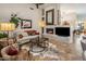 Cozy living room with fireplace, TV, comfortable seating, and natural light at 6767 E Nightingale Star Cir, Scottsdale, AZ 85266