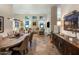 Spacious living room with modern lighting fixtures and stylish furniture, open layout to dining area at 6767 E Nightingale Star Cir, Scottsdale, AZ 85266