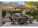 Outdoor patio with stone kitchen, stainless grill, dining table and chairs, with mountain views at 6767 E Nightingale Star Cir, Scottsdale, AZ 85266