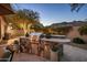 Outdoor kitchen with stone accents, stainless steel grill, and bar seating perfect for grilling at 6767 E Nightingale Star Cir, Scottsdale, AZ 85266