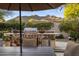 Outdoor kitchen with stone countertop grill, and a view of the mountain at 6767 E Nightingale Star Cir, Scottsdale, AZ 85266