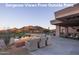 Relaxing outdoor patio with a fire pit and comfortable seating overlooking mountain views at 6767 E Nightingale Star Cir, Scottsdale, AZ 85266