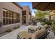 Spacious patio area with lounge chairs, a dining set, and beautiful landscaping at 6767 E Nightingale Star Cir, Scottsdale, AZ 85266