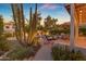 Inviting backyard with a desert-style landscape, outdoor dining, and ambient lighting at 6841 S Roosevelt St, Tempe, AZ 85283