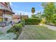 A spacious backyard with decorative landscape beds and lush green lawn at 6841 S Roosevelt St, Tempe, AZ 85283