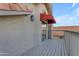 Exterior view of the balcony featuring a wooden deck, a railing, and an awning at 6841 S Roosevelt St, Tempe, AZ 85283